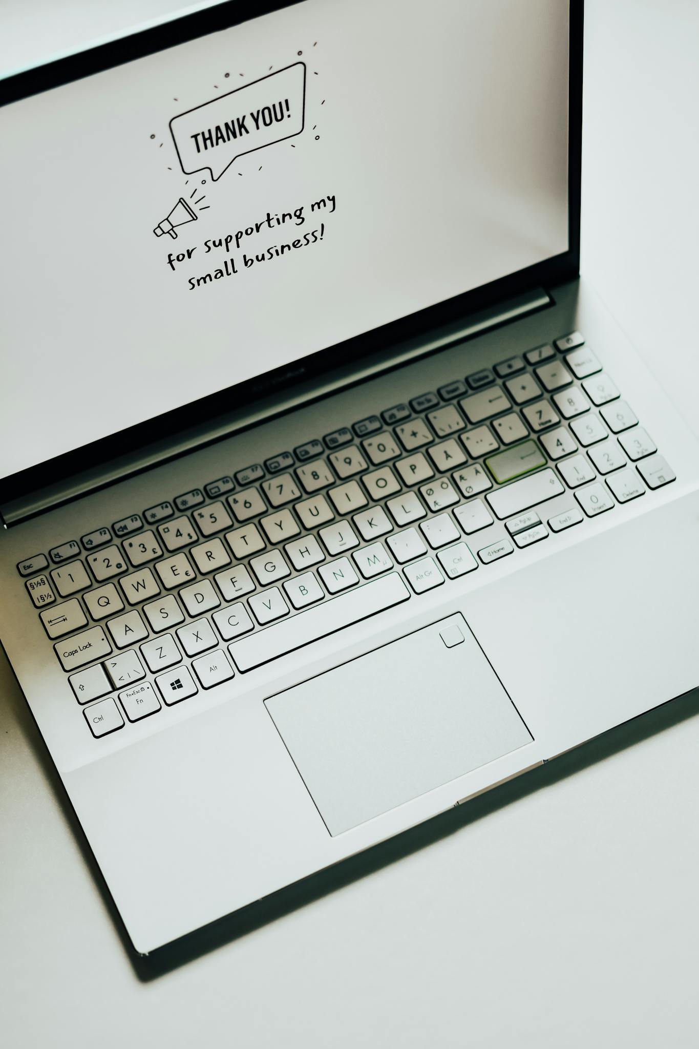 This close-up image shows a laptop displaying a thank you message for supporting small businesses.
